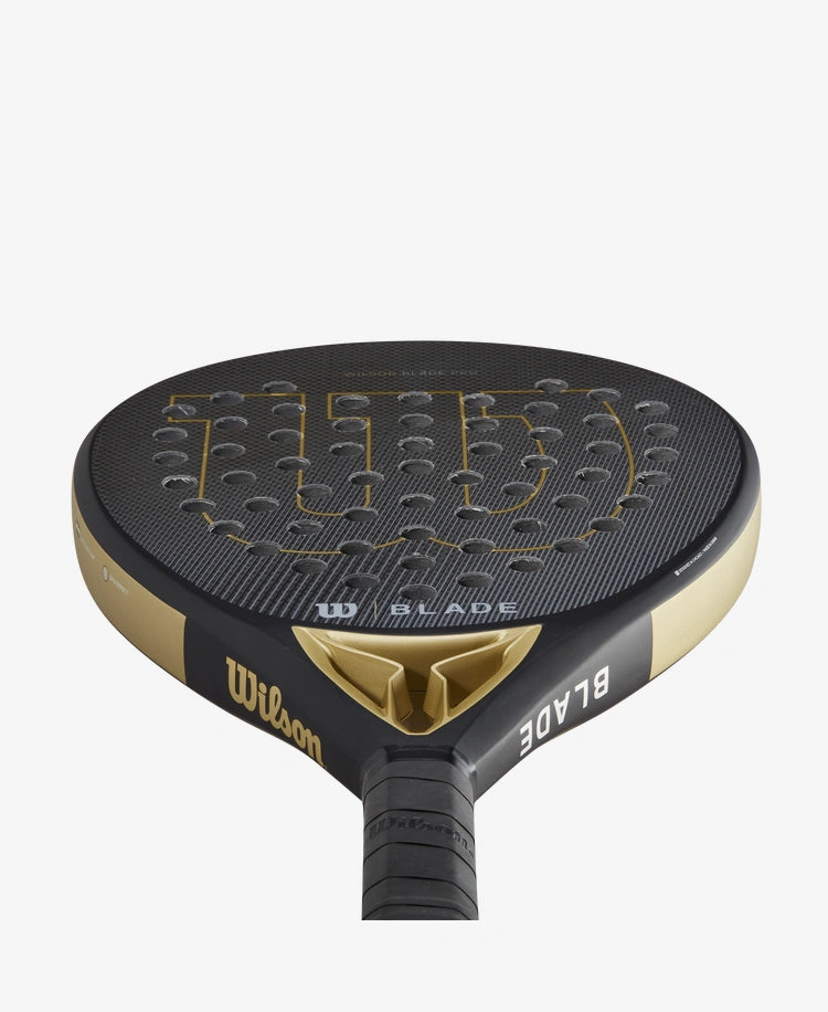      WR067221U__6432ef84d56341638e558c779f31358d 1556 × 1900px The Wilson Blade Pro V2 Padel Racket in gold colour which is available for sale at GSM Sports.