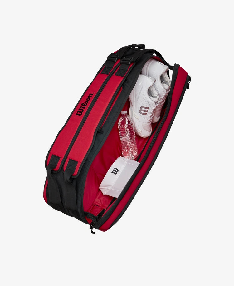 The Wilson Clash V2 Super Tour 6 Pack Racket Bag with tennis equipment inside for display purposes which is available for sale at GSM Sports.
