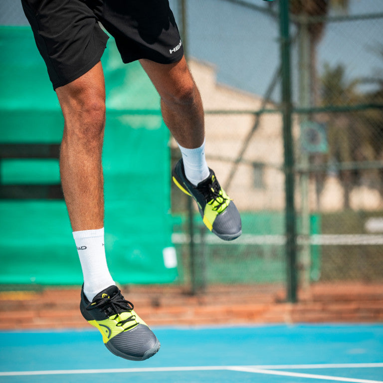 The collection of colours of the Head Revolt Pro 4.0 Mens Tennis Shoes on a tennis court which are available for sale at GSM Sports