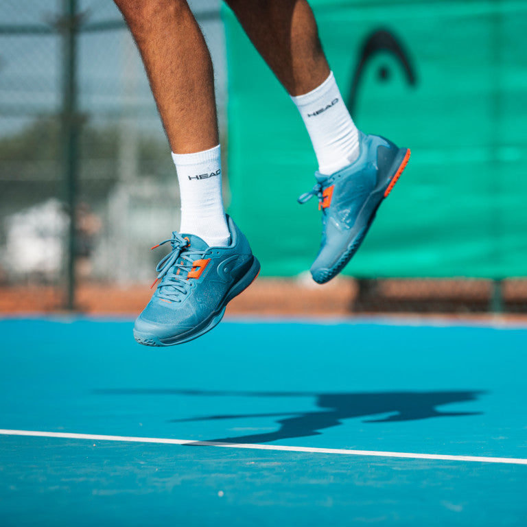 The Head Sprint Pro 3.5 Mens Tennis Shoe in Blue and Orange on a hard court available at GSM Sports