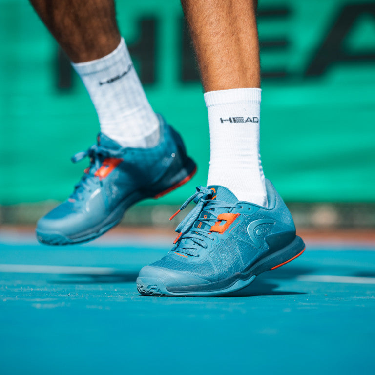 The Head Sprint Pro 3.5 Mens Tennis Shoe in Blue and Orange on a hard court available at GSM Sports