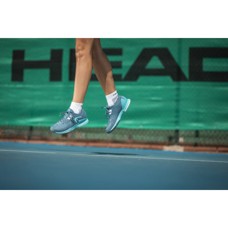 The Head Sprint Pro 3.5 Women's Tennis Shoes in blue on a tennis court available at GSM Sports