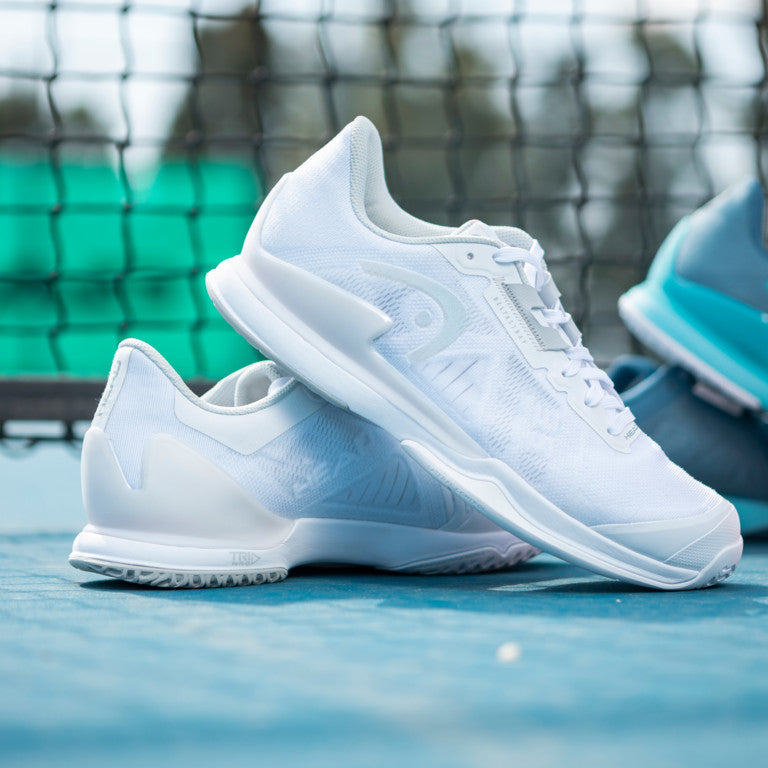 The Head Sprint Pro 3.5 Women's Tennis Shoes in White on a tennis court which available for sale at GSM Sports